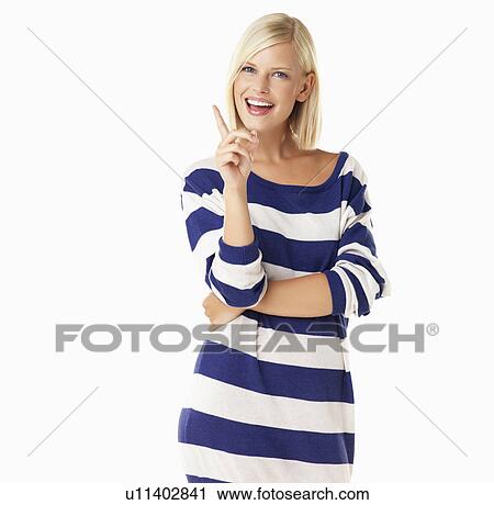 Stock Image - Studio portrait of young woman wagging finger. Fotosearch