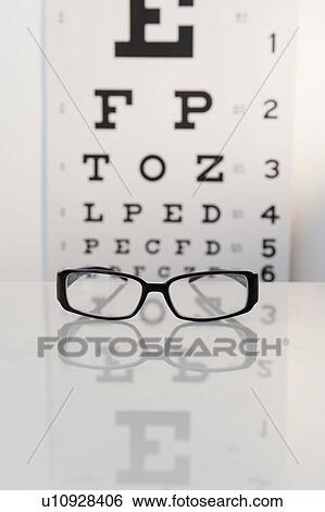 Stock Photograph - Studio shot of eyeglasses and eye chart. Fotosearch