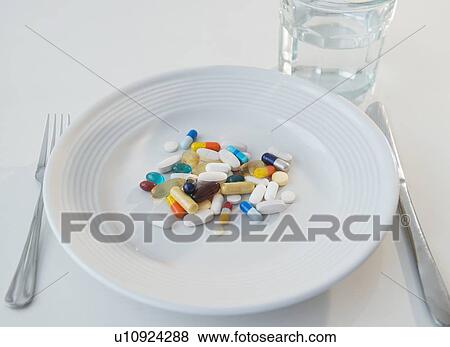 Stock Photo - Studio shot of pills on plate. Fotosearch