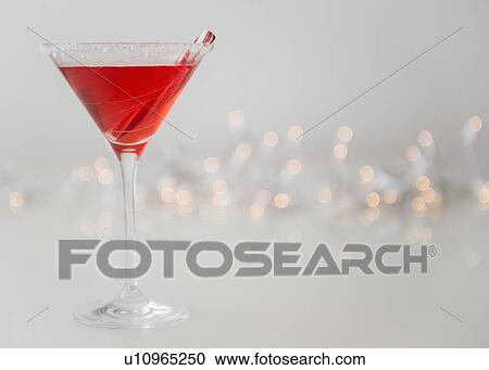 Stock Image - Studio shot of red cocktail in martini glass. Fotosearch