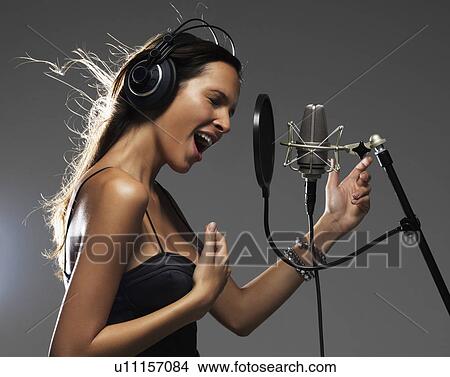 Picture - Studio shot of singing rockstar. Fotosearch