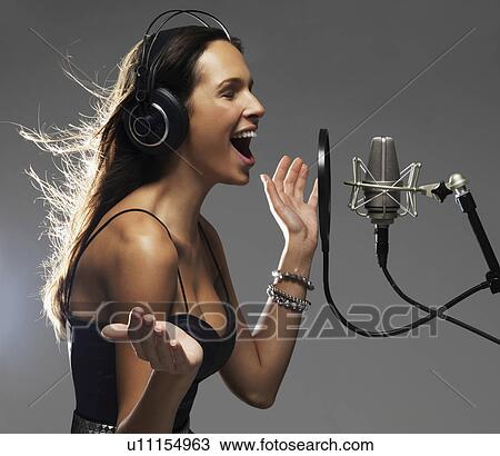 Stock Image - Studio shot of singing rockstar. Fotosearch