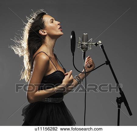 Stock Image - Studio shot of singing rockstar. Fotosearch