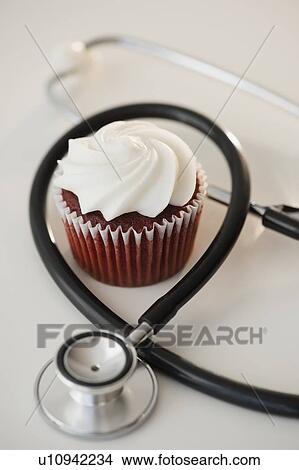 Picture - Studio shot of stethoscope and cupcake. Fotosearch