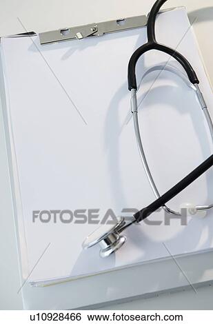 Stock Photograph - Studio shot of stethoscope and clipboard with blank paper. Fotosearch