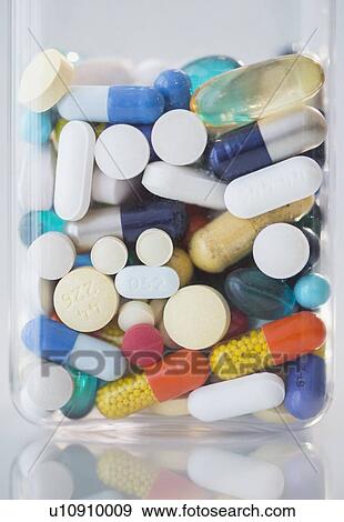 Stock Photo - Studio shot of various pills in bottle. Fotosearch