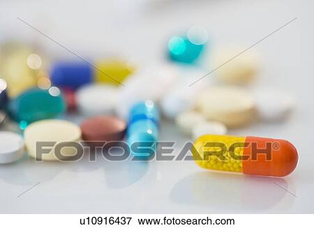 Stock Photo - Studio shot of various pills in bottle. Fotosearch
