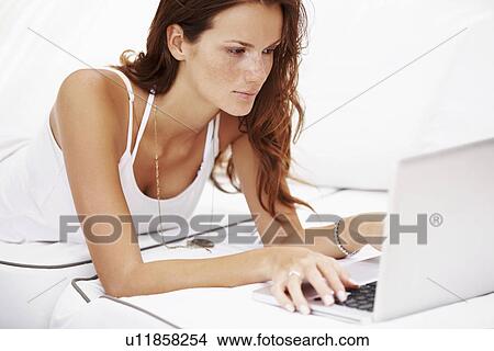 Studio shot of woman using laptop View Large Photo Image Picture - Studio shot of woman using laptop. Fotosearch