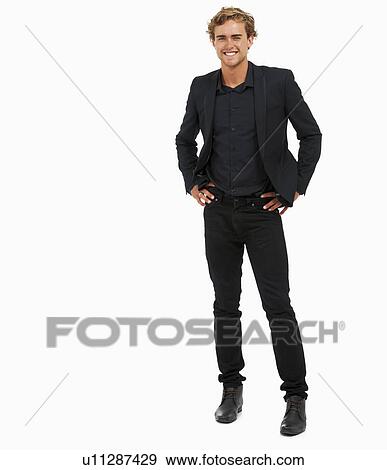 Stock Photo - Studio Shot of young man with hands on hips. Fotosearch