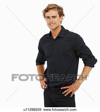 Stock Photo - Studio Shot, Portrait of man with hands on hips. Fotosearch