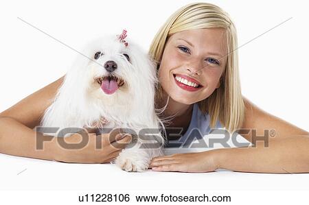 Studio Shot, Portrait of smiling young woman with her dog View Large Photo Image Stock Photograph - Studio Shot, Portrait of smiling young woman with her dog. Fotosearch