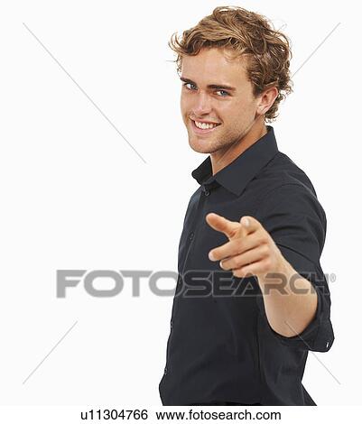 Stock Photograph - Studio Shot, Portrait of young man pointing. Fotosearch
