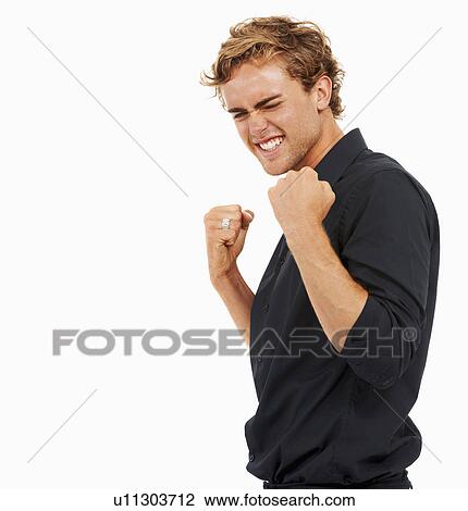 Studio Shot, Portrait of young man with arms raised and clenched fists View Large Photo Image Stock Image - Studio Shot, Portrait of young man with arms raised and clenched fists. Fotosearch
