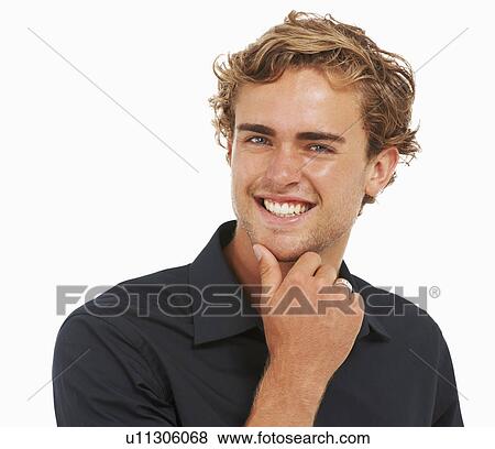 Studio Shot, Portrait of young man with hand on chin View Large Photo Image Stock Photo - Studio Shot, Portrait of young man with hand on chin. Fotosearch