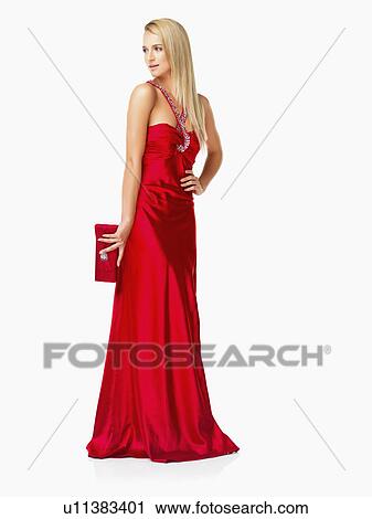 Stock Image - Studio Shot, Portrait of young woman in red dress. Fotosearch