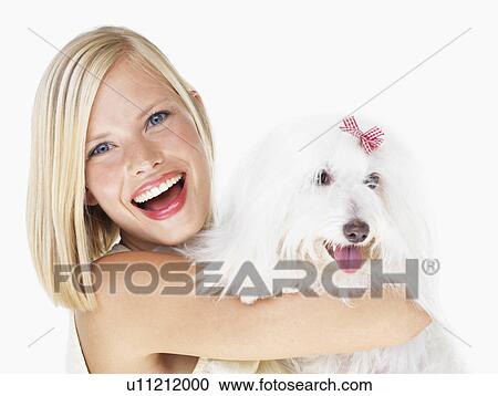 Studio Shot, Portrait of young woman holding dog View Large Photo Image Stock Image - Studio Shot, Portrait of young woman holding dog. Fotosearch