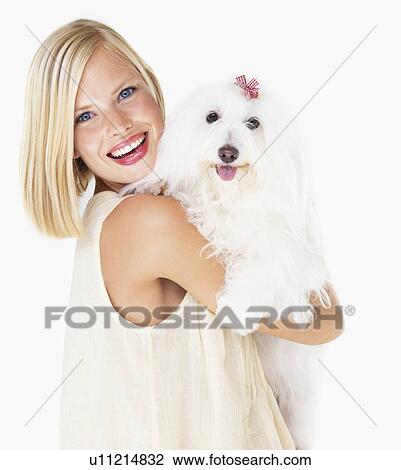 Studio Shot, Portrait of young woman holding dog View Large Photo Image Stock Image - Studio Shot, Portrait of young woman holding dog. Fotosearch