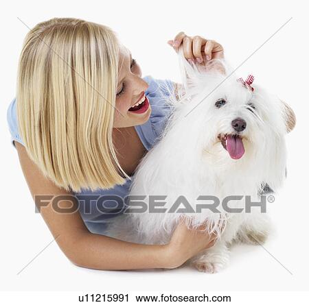 Studio Shot, Portrait of young woman stroking her dog View Large Photo Image Stock Image - Studio Shot, Portrait of young woman stroking her dog. Fotosearch