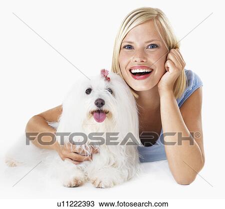 Studio Shot, Portrait of young woman lying down, hugging her dog View Large Photo Image Stock Image - Studio Shot, Portrait of young woman lying down, hugging her dog. Fotosearch