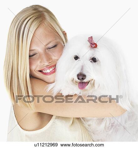 Studio Shot, Portrait of young woman holding dog View Large Photo Image Stock Photo - Studio Shot, Portrait of young woman holding dog. Fotosearch