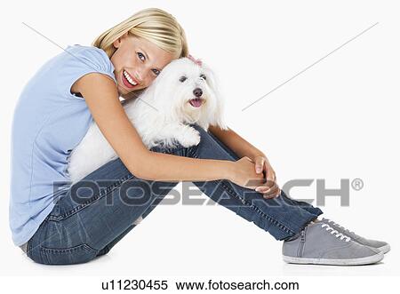 Studio Shot, Portrait of young woman sitting and holding dog View Large Photo Image Stock Photography - Studio Shot, Portrait of young woman sitting and holding dog. Fotosearch
