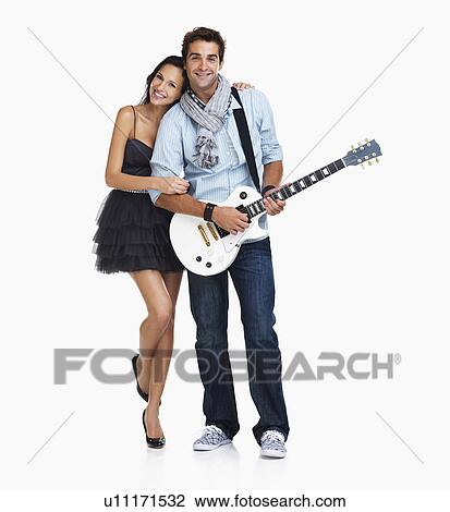 Studio Shot, Young woman embracing guitarist View Large Photo Image Stock Image - Studio Shot, Young woman embracing guitarist. Fotosearch
