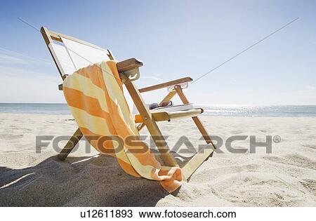 Stock Image - Sun chair on sandy beach. Fotosearch