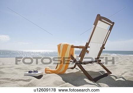Sun chair on sandy beach View Large Photo Image Stock Photo - Sun chair on sandy beach. Fotosearch