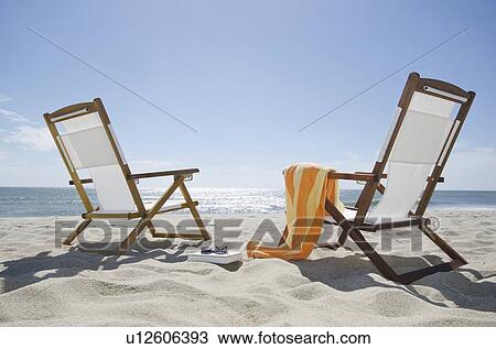 Sun chairs on sandy beach View Large Photo Image Stock Image - Sun chairs on sandy beach. Fotosearch