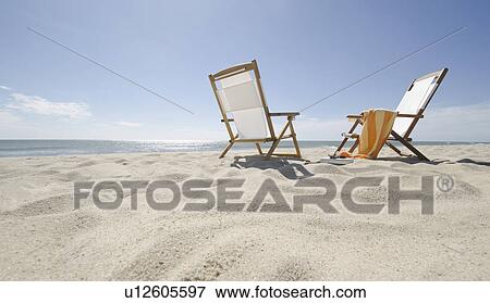 Sun chairs on sandy beach View Large Photo Image Stock Photo - Sun chairs on sandy beach. Fotosearch