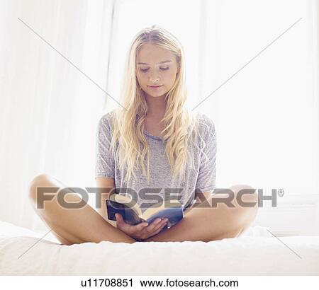 Teen (16-17) girl reading on bed View Large Photo Image Stock Image - Teen (16-17) girl reading on bed. Fotosearch