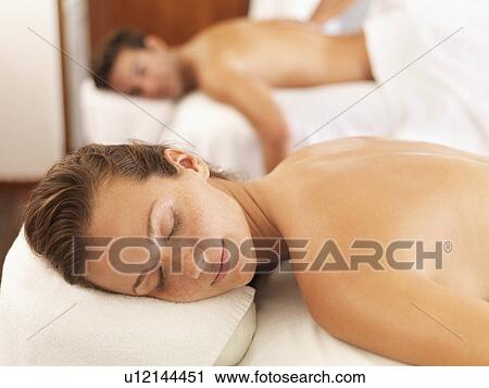 Stock Image - Two people getting massage in spa. Fotosearch