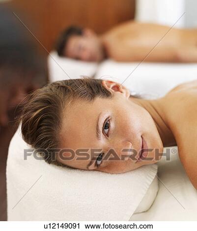 Stock Image - Two people getting massage in spa. Fotosearch