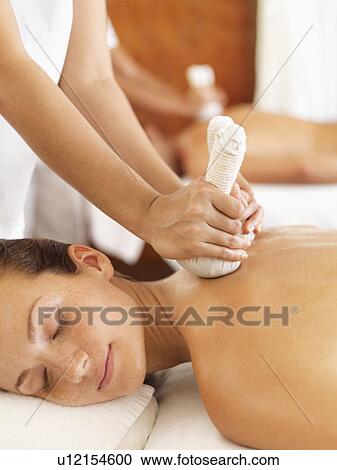 Stock Image - Two people getting massage in spa. Fotosearch