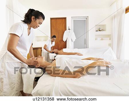 Two people getting massage in spa View Large Photo Image Stock Photo - Two people getting massage in spa. Fotosearch