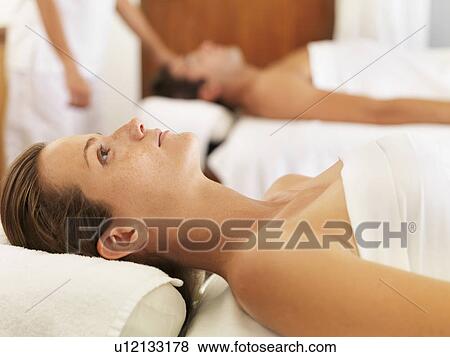 Stock Photo - Two people getting massage in spa. Fotosearch