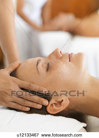 Stock Photo - Two people getting massage in spa. Fotosearch