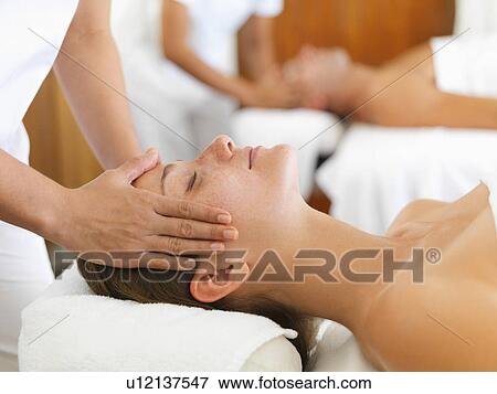 Stock Photo - Two people getting massage in spa. Fotosearch