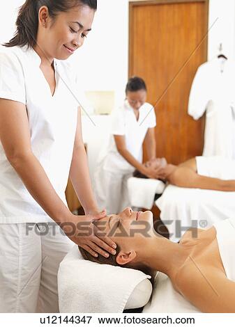 Two people getting massage in spa View Large Photo Image Stock Photo - Two people getting massage in spa. Fotosearch