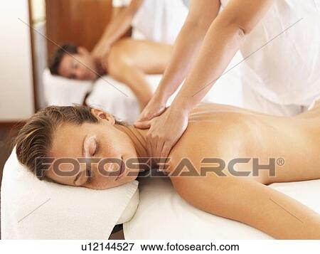 Stock Photo - Two people getting massage in spa. Fotosearch