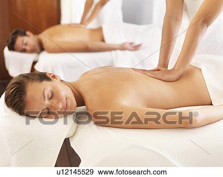 Stock Photo - Two people getting massage in spa. Fotosearch