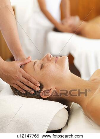 Stock Photography - Two people getting massage in spa. Fotosearch