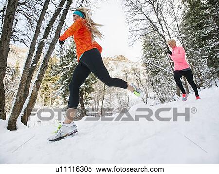 Two women jogging in winter forest View Large Photo Image Stock Photography - Two women jogging in winter forest. Fotosearch
