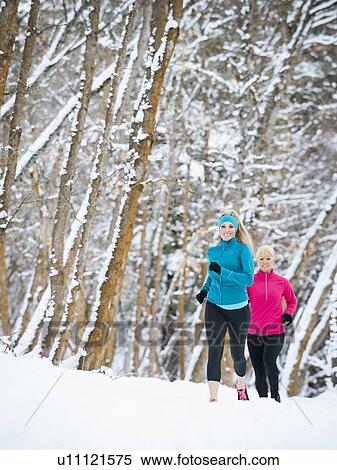 Two women jogging in winter forest View Large Photo Image Stock Photography - Two women jogging in winter forest. Fotosearch