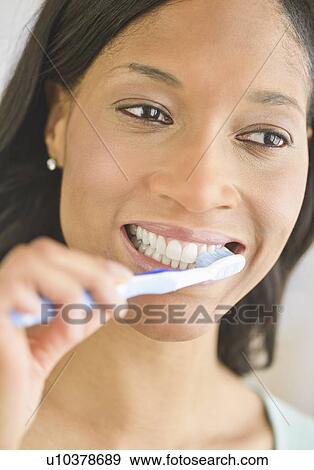 Stock Photo - Woman brushing teeth. Fotosearch