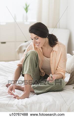 Woman doing pedicure in bedroom View Large Photo Image Stock Photo - Woman doing pedicure in bedroom. Fotosearch