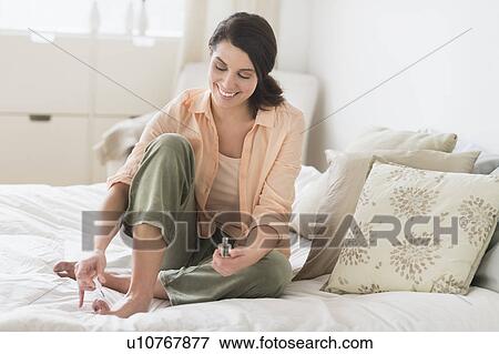 Woman doing pedicure in bedroom View Large Photo Image Stock Photo - Woman doing pedicure in bedroom. Fotosearch