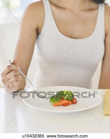 Woman eating vegetables View Large Photo Image Stock Photography - Woman eating vegetables. Fotosearch