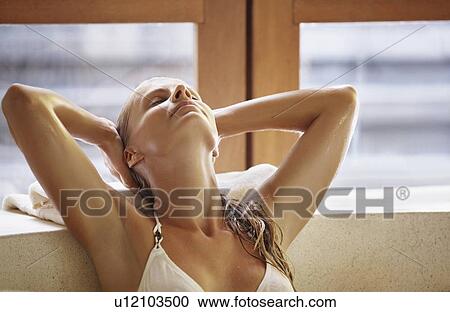 Stock Image - Woman enjoying bath spa. Fotosearch