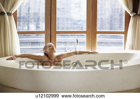 Stock Photo - Woman enjoying bath spa. Fotosearch